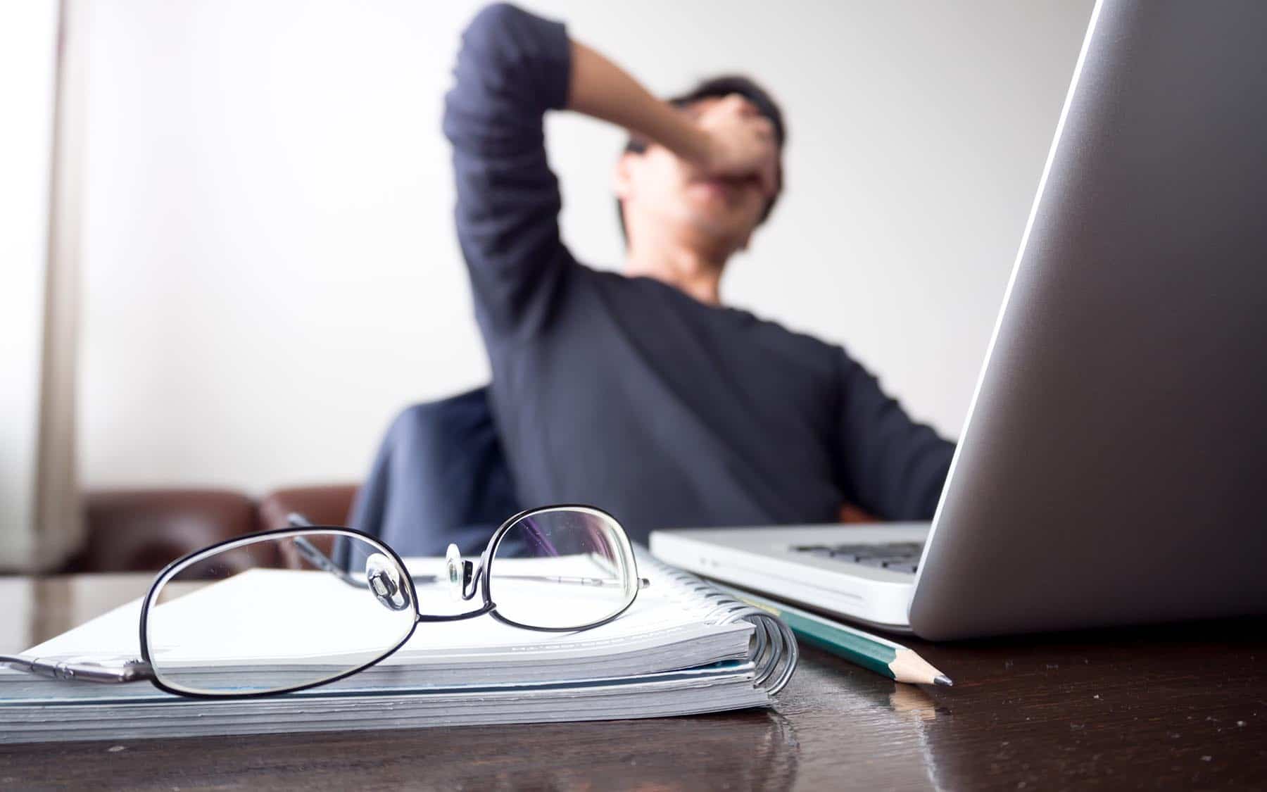 How stress affects sleep - Man at laptop