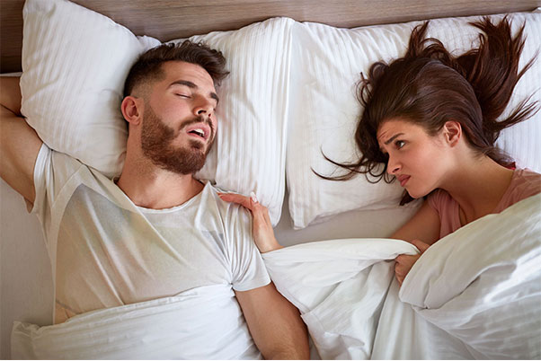 Couple in Bed - Waking partner with Sleep Apnea