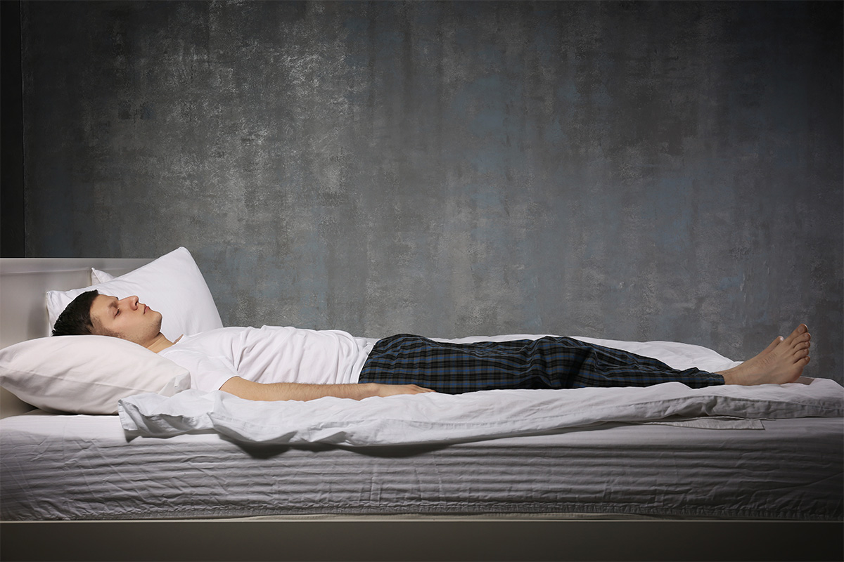 Man in bed experiencing sleep paralysis